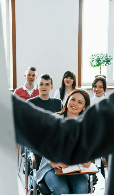 Showing data. Group of people at business conference in modern classroom at daytime.